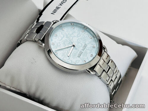 1st picture of NINE WEST BLUE DIAL FLORAL DESIGN CRYSTAL ACCENTED SILVER BRACELET STRAP WATCH For Sale in Cebu, Philippines