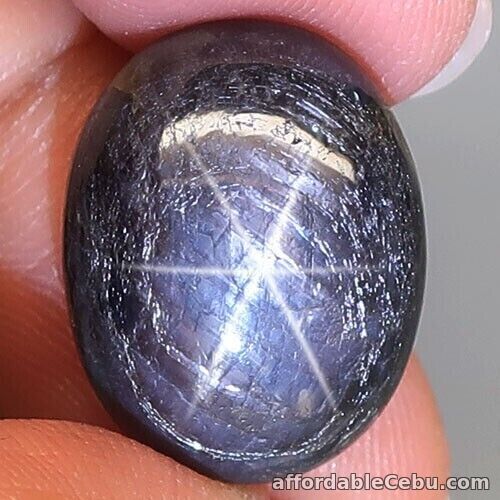 1st picture of 15.94 Carats Natural Star SAPPHIRE 6 Rays Black 16.5x13x6.6mm Oval Cabochon For Sale in Cebu, Philippines