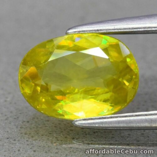 1st picture of 0.94 Carat Natural Greenish Yellow SPHENE (Rainbow Spark Under Sun Light)  Oval For Sale in Cebu, Philippines