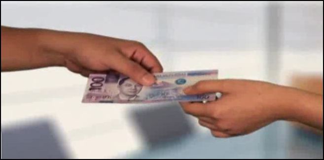 A New Philippine Peso Bill handed to someone